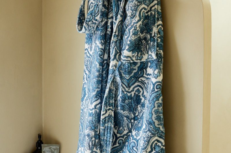 Spa like bathroom with a blue patterned bath robe.