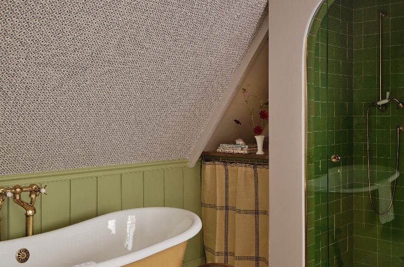 A farmhouse chic project with clever storage, a curved, closed shower area, a yellow freestanding tub and neutral flooring.