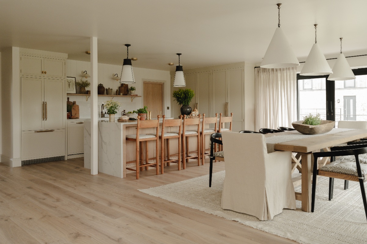 A neutral, country style kitchen in an L-shape with a sociable island and an adjoining dining area.