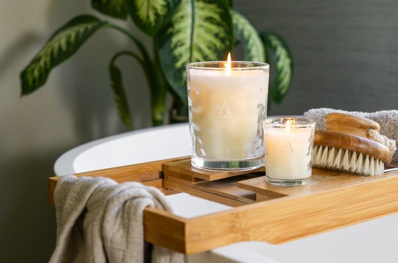 A wood bath caddy with spa candles.