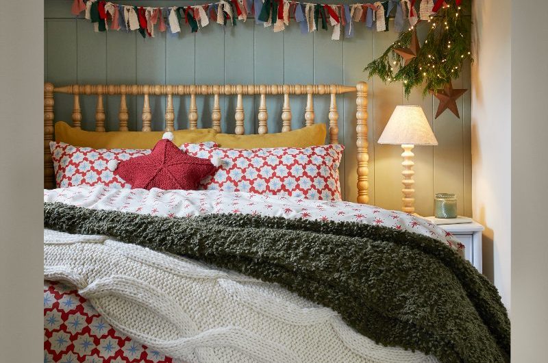 A maximalist scheme with blue panelling, patterned wallpaper and quirky furnishings.