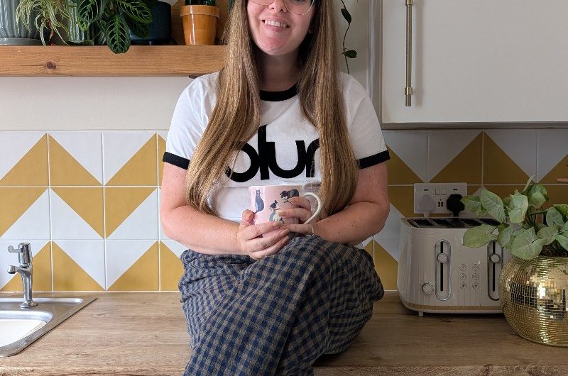 A homeowner in her colourful kitchen.