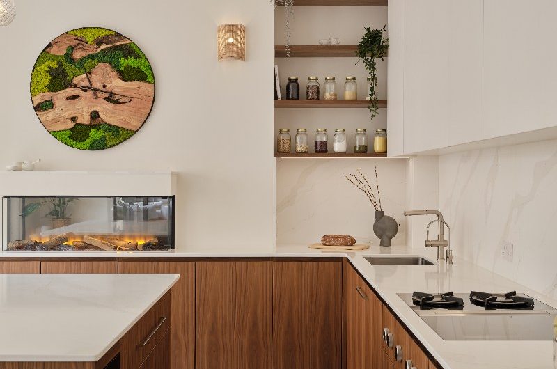 A look at the L-shaped modern kitchen with walnut units and a central island.