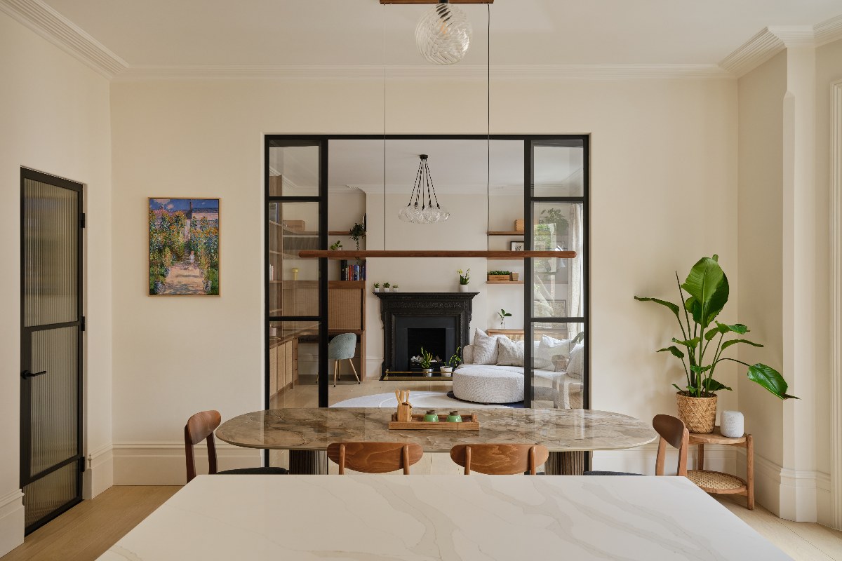 View inside the home office from the kitchen through steel-framed doors.