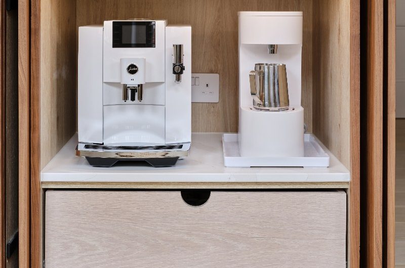 A small appliance cupboard within the island with pocket doors.