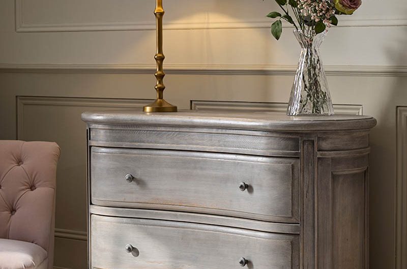 A curved sideboard crafted from wood in a neutral, sophisticated scheme.